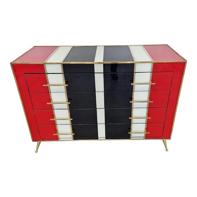 4 drawer dresser, entirely handmade, with wooden structure, covered in red, black and white glass, profiles and golden...