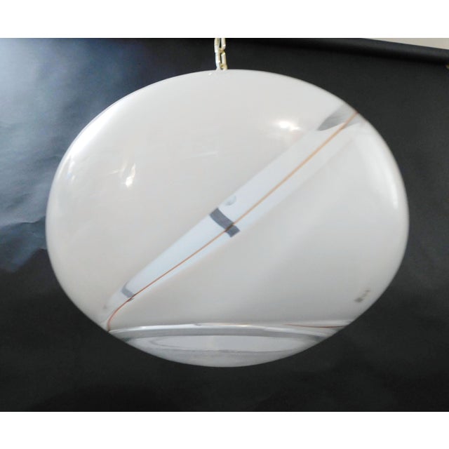 Vintage Italian pendant with a single large milky white Murano glass shade hand blown with a clear and brown swirl stripe...