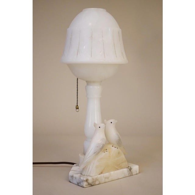 A sophisticated and elegant hand carved milky White Alabaster Marble Art Deco "Fairy" style table lamp with a charming...