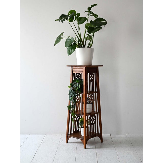 Oak pedestal, Scandinavia, early 1900s, with four shelves and perforated motifs in the Nordic Jugendstil style....