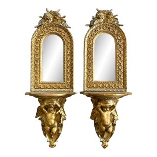 Antique Carved Giltwood Hanging Shelves With Arched Mirror and Putti - a Pair For Sale