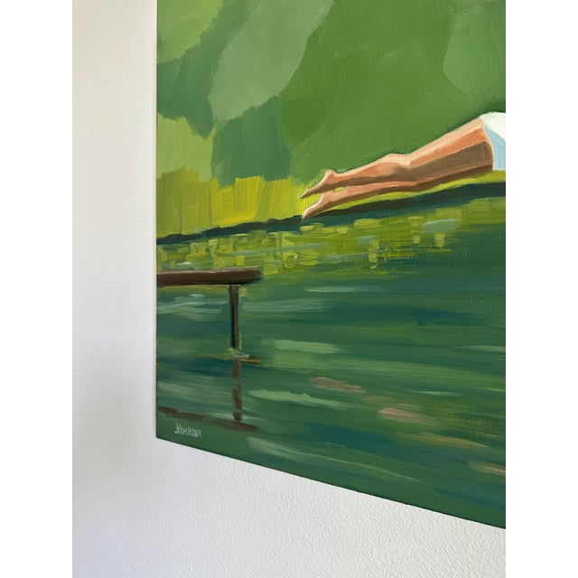 The many shades of green in this painting offset by the white of the diver's suit and swim cap bring a feeling of...