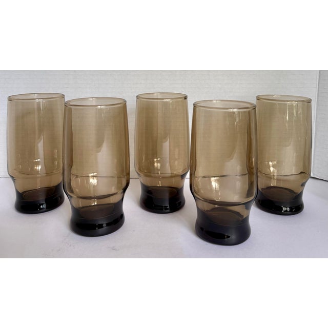 Dating to the mid-20th century, this handsome set of five beverage glasses embodies the understated elegance that defined...