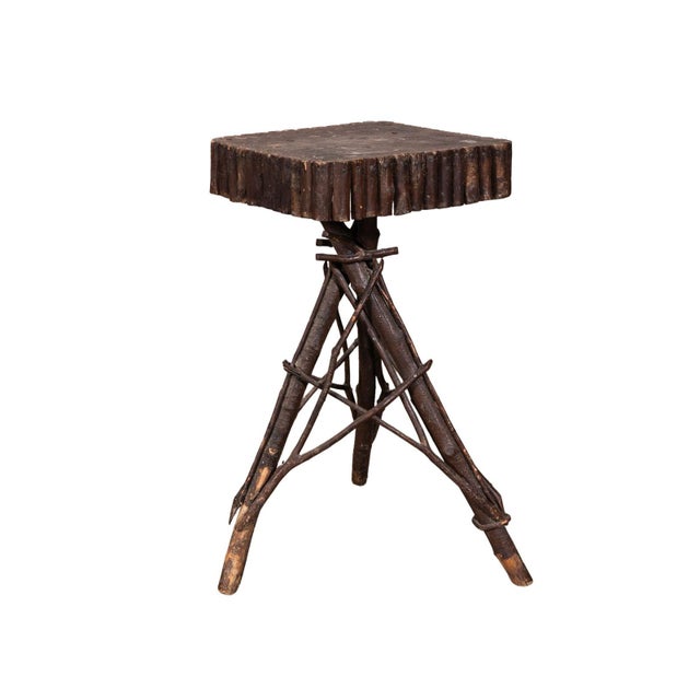 Adirondack style side table with square bark-covered branch top. Bent twigs and branches on the tripod style base. Natural...