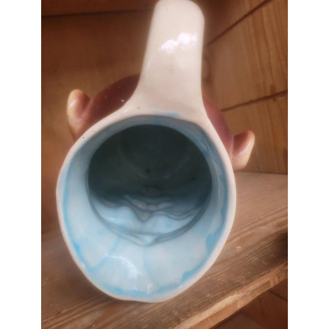 Pichet in anthropomorphic barbotine. "Grotesque" head, production of Sarreguemines. This water or wine pitcher represents...