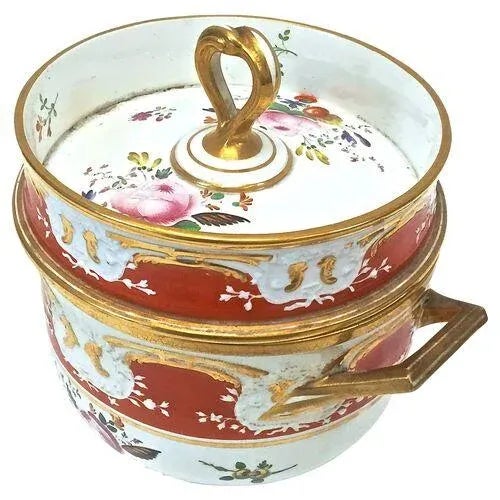 Antique porcelain floral two-piece sorbetière intricately hand-painted with floral and gilded accents. The bottom piece...