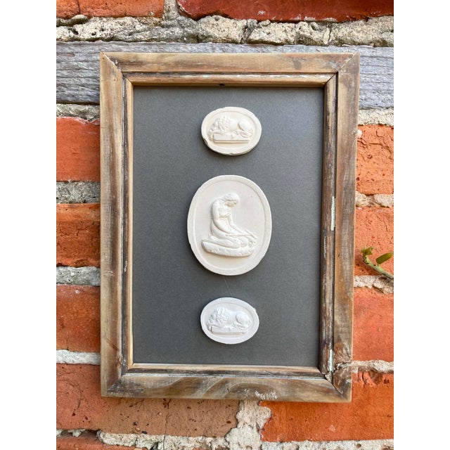 Immerse yourself in the enduring allure of classical antiquity with this truly unique collection of framed intaglios....