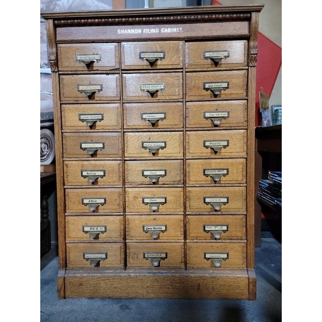 An American tiger oak file cabinet with 24 individual drawers. Circa. 1900. Retains makers label "Shannon Filing Cabinet"....