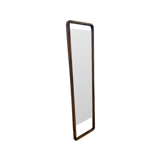 This tall mirror features a smooth, rounded rectangular frame in a rich wood finish. Its slim silhouette and open design...