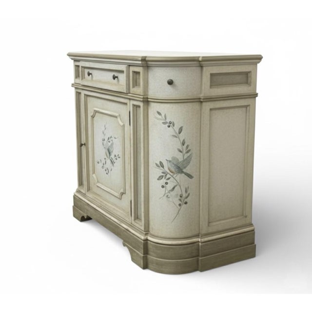 This elegant, hand-painted commode captures the essence of provincial French charm. Featuring a unique modified demilune...