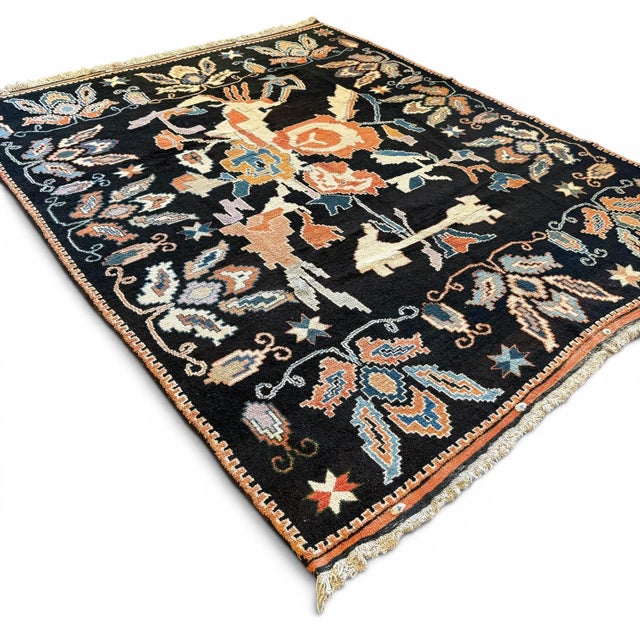 A striking example of late 20th-century Anatolian design, this vintage Turkish rug features an expressive floral...