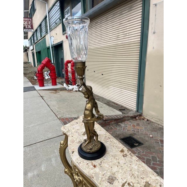 Add charm and ambiance to any room of your home with this tall 30” bronze and glass candle holder.