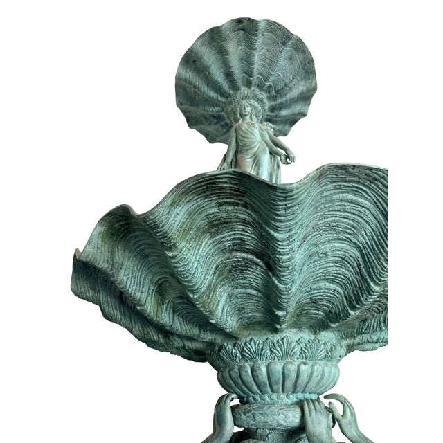Monumental multi-tier classical style fountain featuring richly sculpted female figures, children, and dramatic shell-form...
