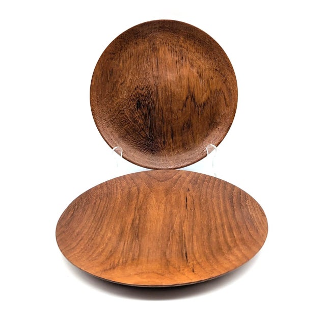 Offered is a pair of mid 20th Century, circa. 1950s to early 1960s carved and lathed Teak wood plates made in Japan. There...