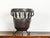 An English metal brazier /pot from the mid 20th century, with knotted motifs and scrolling feet. Created in England during...