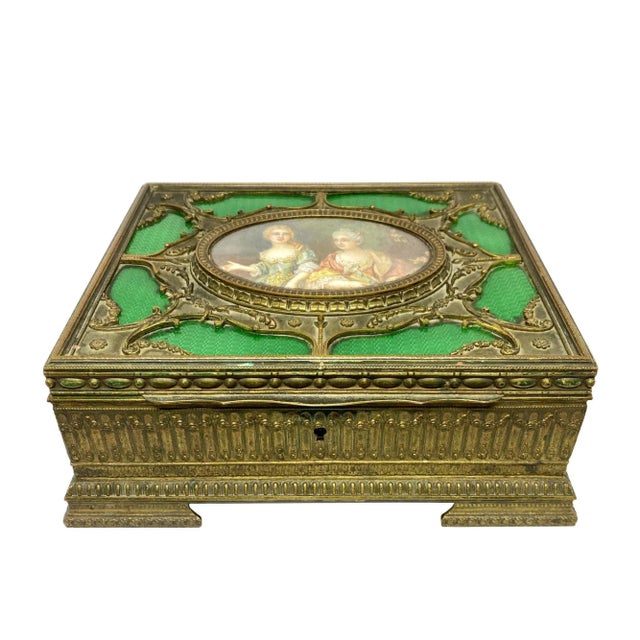 This is a wonderful late 19th century French bronze and enamel jewel box with a miniature painting of two women set in the...
