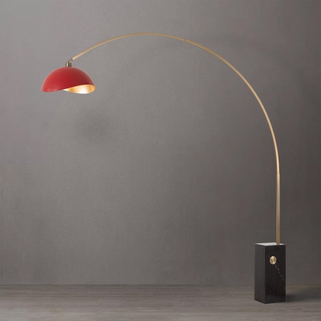 The Iconic Arc Lamp is a Mid-Century Modern arc lamp featuring a Weathered Brass steel body and a striking Half-Dome Matte...