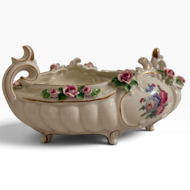 The Dresden Germany Porcelain Rose Console Rococo-style bowl featuring pink-tinted and rose-decorated body with ornate...