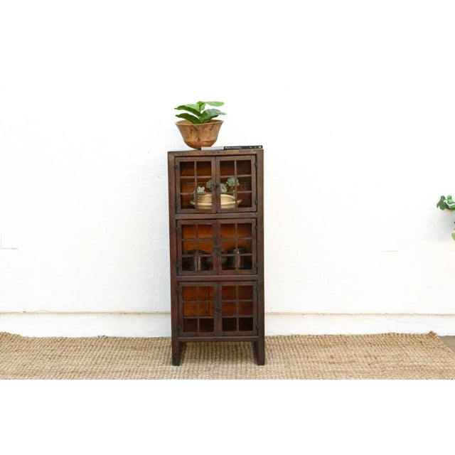 Antique kitchen cabinet with lattice doors: This antique kitchen cabinet, with its charming lattice doors and aged painted...