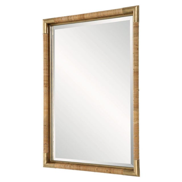 The Kamp mirror is made with an iron frame accented in a heavily antiqued gold featuring a hand wrapped natural rattan....