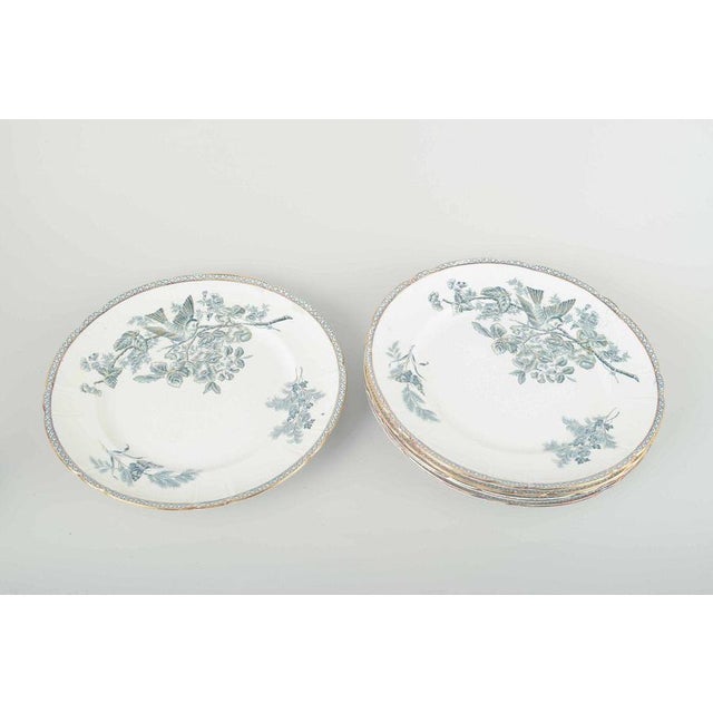 Gustavsberg “Wexiö” faience, c. 1900. Five dinner plates in faience with printed decoration of a bird and flowering branch...