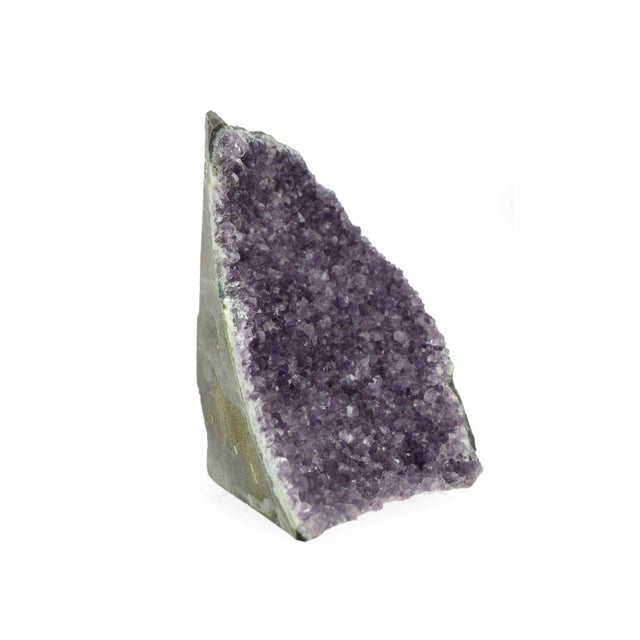 This decorative purple quartz geode is a unique piece that brings the wonders of the natural world indoors. Its...