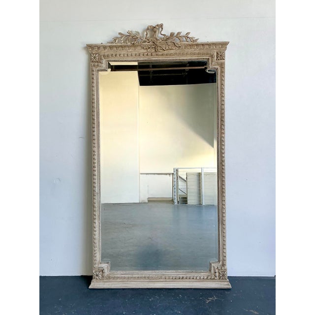 This monumental floor mirror is a breathtaking statement piece, embodying the refined elegance of French Neoclassical...