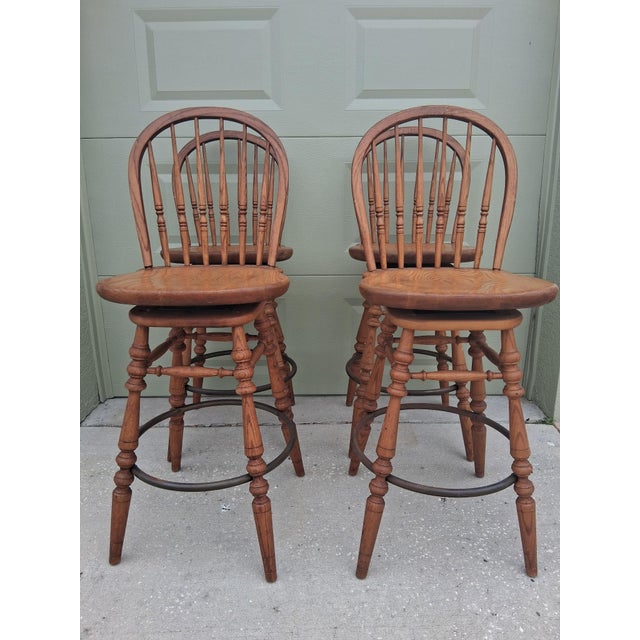 Stunning Set of 4 Vintage 1950's Colonial Solid Oak Swivel Bar Stools by Ethan Allen. These are gorgeous and a rare set of...