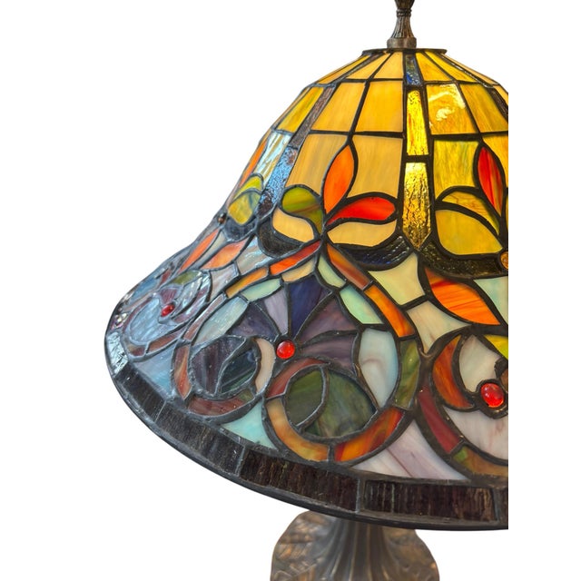 A beautifully crafted stained glass table lamp inspired by the timeless artistry of Tiffany Studios and the Art Nouveau...