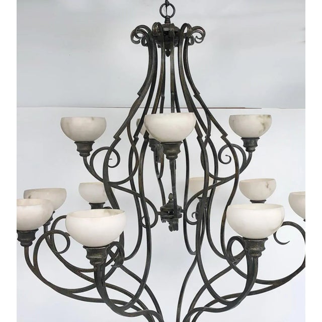 Pasquale Miranda for Feiss Iron and Alabaster Chandelier 20th Century Offered for sale is a large 12 arm chandelier...