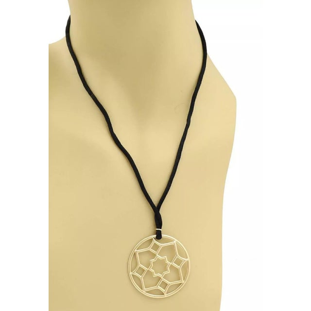 This lovely authentic pendant and black cord necklace is from Tiffany & Co. by designer Paloma Picasso from her Zellige...