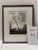 Atmospheric black-and-white landscape print by American artist Robert Kipniss, depicting slender trees framing a small...