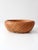 A vintage handwoven bamboo basket bowl featuring a rounded silhouette, gently curved rim, and intricate open lattice weave...
