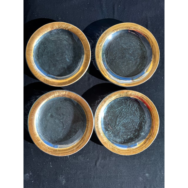 A set of four Annieglass “Roman Antique” appetizer plates, each hand-formed glass with a 24k gold rim. Most examples are...