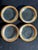 A set of four Annieglass “Roman Antique” appetizer plates, each hand-formed glass with a 24k gold rim. Most examples are...