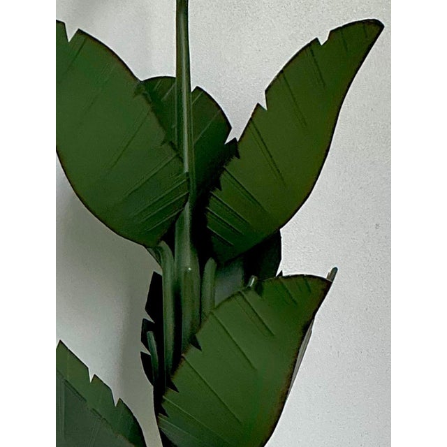 This vintage six-arm chandelier is crafted from metal in the whimsical form of banana leaves, striking a playful yet...