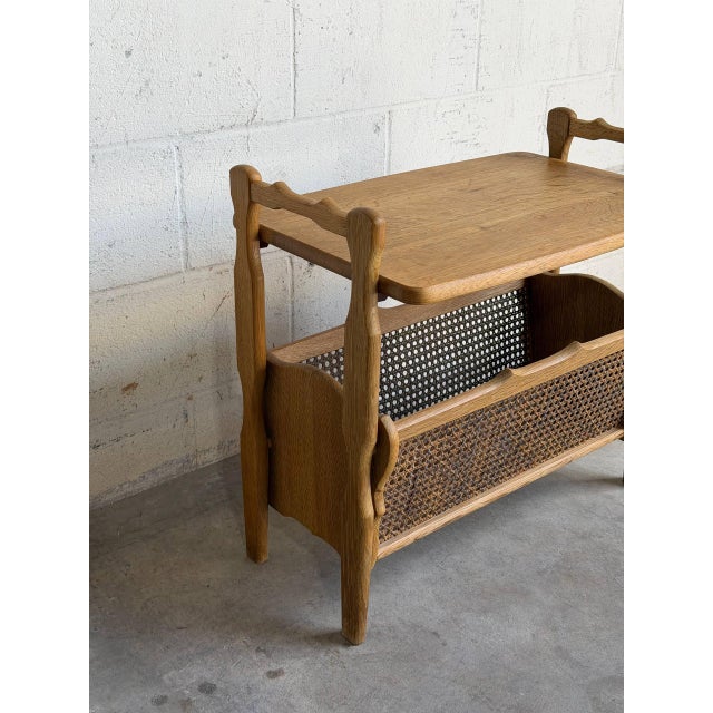 Beautiful vintage Danish side table crafted in oak with an integrated woven cane magazine rack. The piece features...