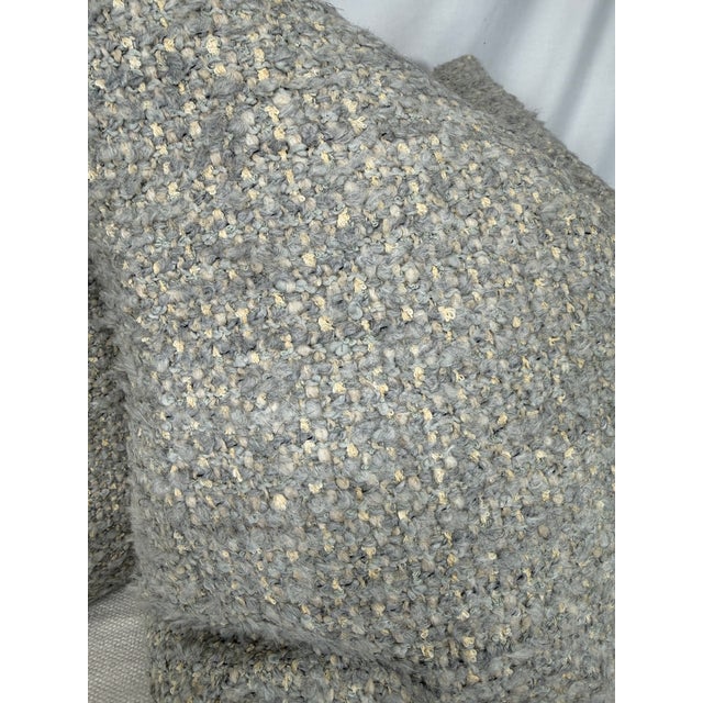 Custom pair of 22" pillows covered in Holly Hunt "Cardigan" in color silver blue boucle fabric. These pillows have tapered...