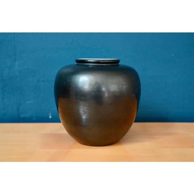 This lovely spherical vase is a product of the Elchinger pottery. Its simple form is highlighted by the famous black...