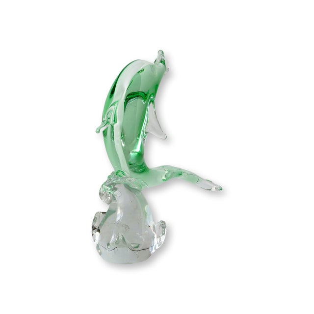 This elegant midcentury Murano glass dolphin sculpture captures the fluid movement and translucence that made Italian art...