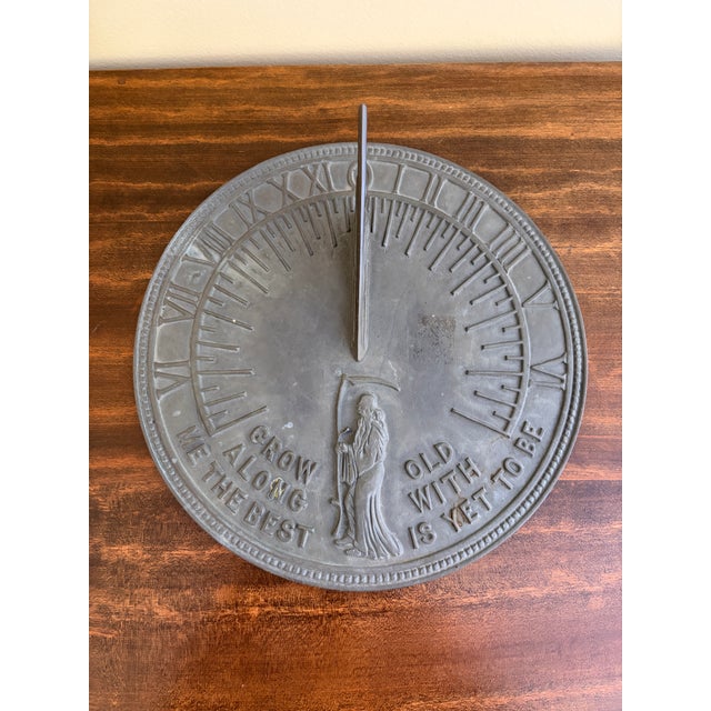 A stunning vintage iron garden sundial reading "Grow old along with me. The best is yet to be." Late 20th Century...