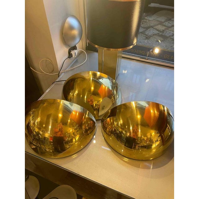 Half-moon brass wall sconce from the 1980s. The lamps are made of semi-polished brass, are relatively large, and can be...