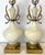 Striking pair of alabaster table lamps from the mid 20th century. These are made of heavy white alabaster with an urn...