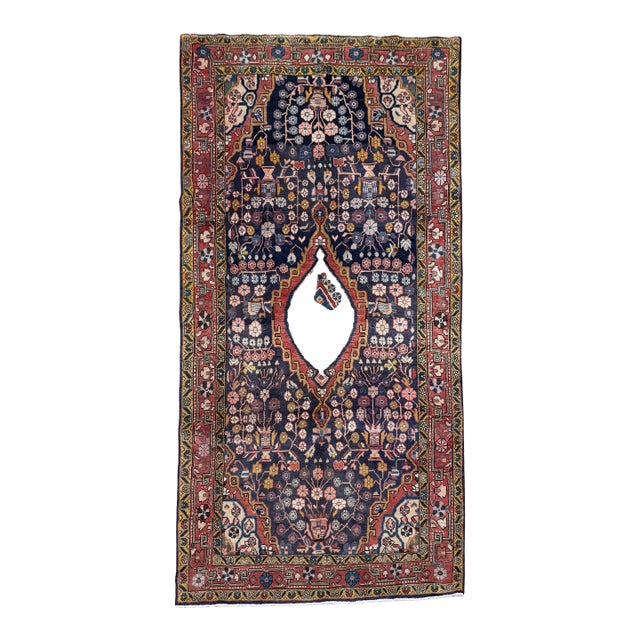 Antique hand-knotted rug from the Arak (Sultanabad) region of central Iran, featuring a vertically oriented vase and...