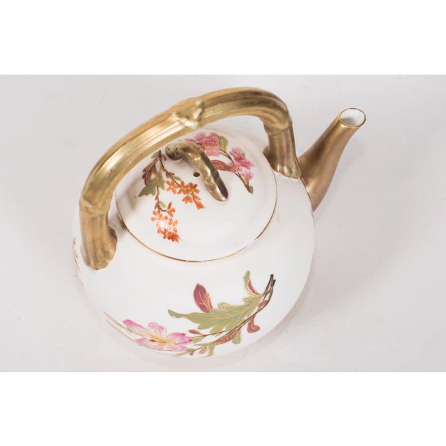 Royal Worcester Bush Ivory Teapot. Hand-painted floral decor. Bamboo handles. Puce Mark for 1887. Makred "W 2010" and "H"...