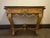 An elegant and generously scaled early-20th-century French Louis XVI-style console, finely carved in giltwood and...