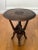 African sculptural carved hardwood side table with a collapsible base, 1960s. Handcrafted by a skilled artisan featuring...