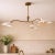 A handcrafted solid brass three-light chandelier featuring asymmetrical arms and white metal shades. Its balanced...