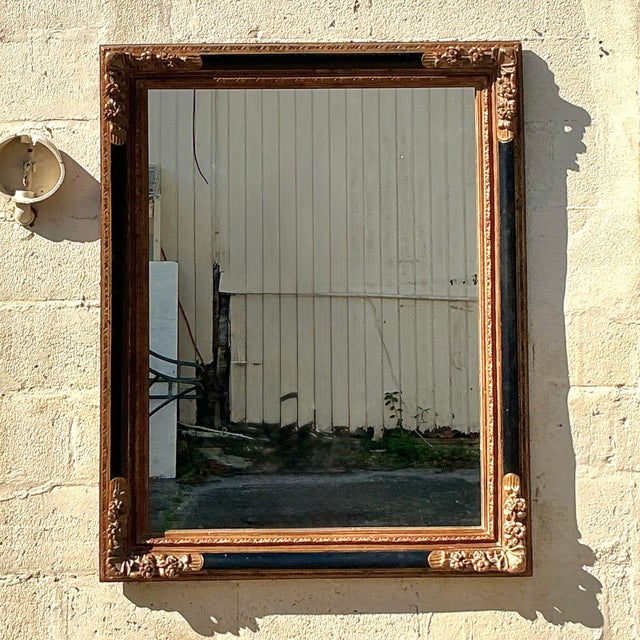 This exquisite vintage Regency mirror exudes timeless elegance with its ornate gilded frame and intricate floral...