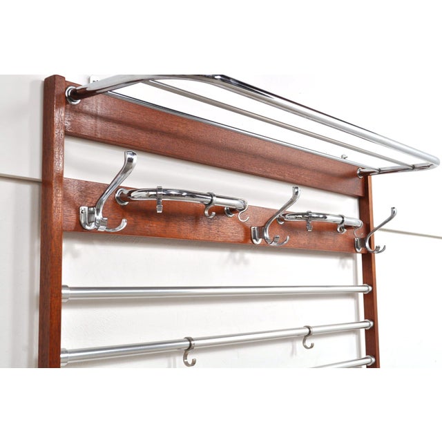 Beautiful large wall coat rack from the 1960s. The mahogany coat rack has many hooks for hanging coats and children's...